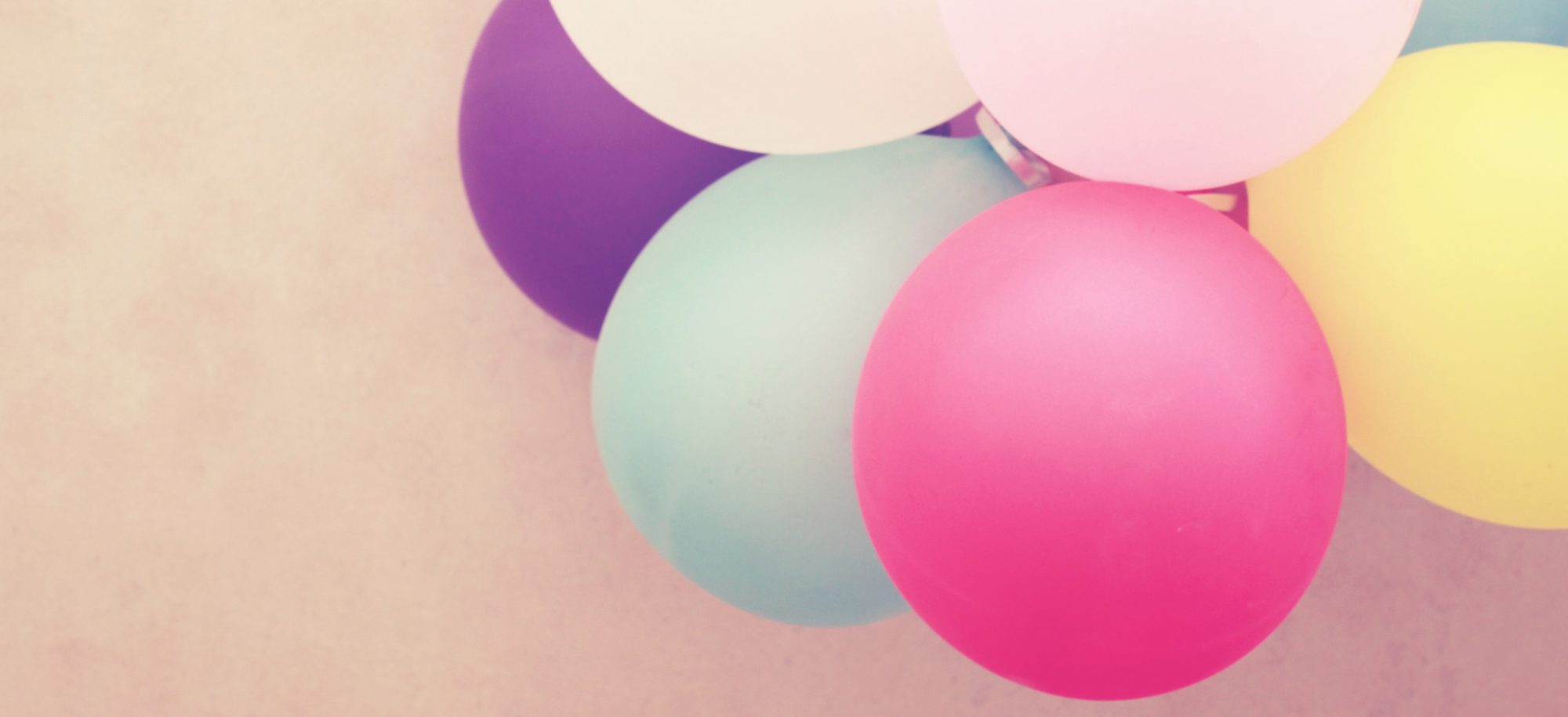 Colorful balloons on wall with retro filter effect